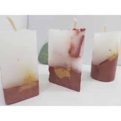 Handmade small triangular candle made of concrete, red with yellow