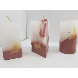 Handmade small triangular candle made of concrete, red with yellow