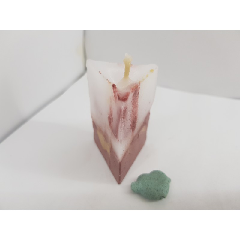 Handmade small triangular candle made of concrete, red with yellow