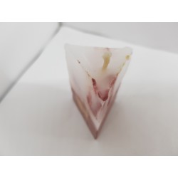 Handmade small triangular candle made of concrete, red with yellow