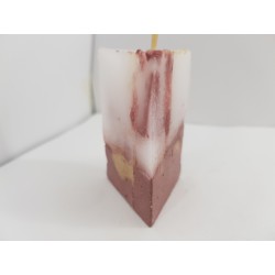 Handmade small triangular candle made of concrete, red with yellow