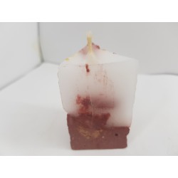 Handmade small triangular candle made of concrete, red with yellow