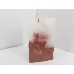 Handmade small triangular candle made of concrete, red with yellow