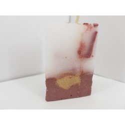 Handmade small triangular candle made of concrete, red with yellow